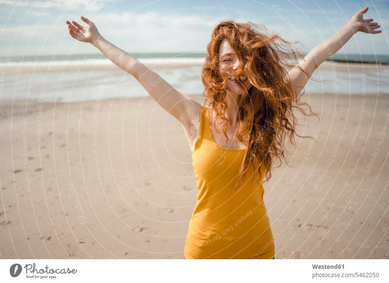 Redheaded woman, laughing happily in the wind summer summer time summery summertime casual leisure wear casual clothing casual wear casual clothes Casual Attire