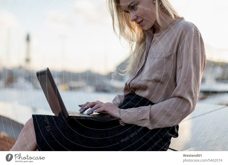 Young businesswoman using laptop at the waterfront businesswomen business woman business women beautiful Laptop Computers laptops notebook business people