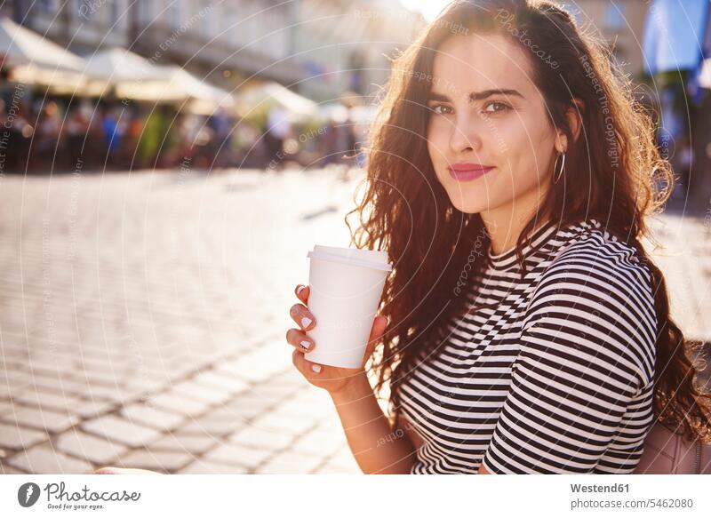 Portrait of beautiful young woman with takeaway coffee in the city portrait portraits Coffee town cities towns females women Drink beverages Drinks Beverage