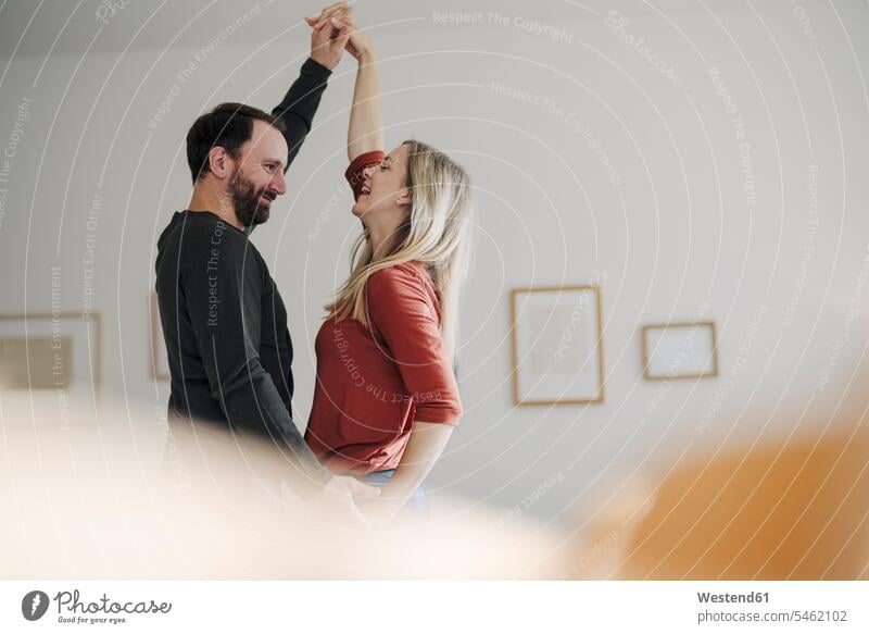 Happy couple dancing at home human human being human beings humans person persons caucasian appearance caucasian ethnicity european 2 2 people 2 persons two