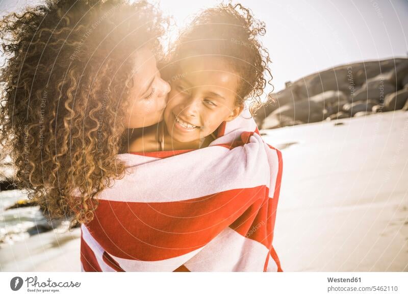 Happy mother and daughter wrapped in a towel on the beach human human being human beings humans person persons Mixed Race mixed race ethnicity mixed-race Person