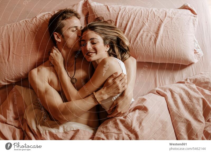 Happy young couple lying in bed human human being human beings humans person persons caucasian appearance caucasian ethnicity european 2 2 people 2 persons two