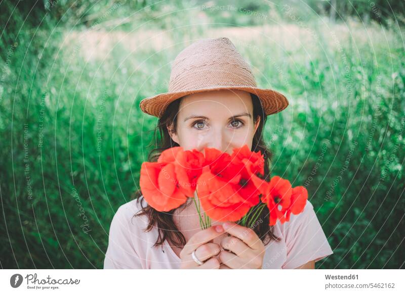 Woman holding a bouquet of red poppies in spring springtime Spring Time spring season Poppy Poppies Corn Poppies Poppy Flowers Papaver rhoeas Red Poppy