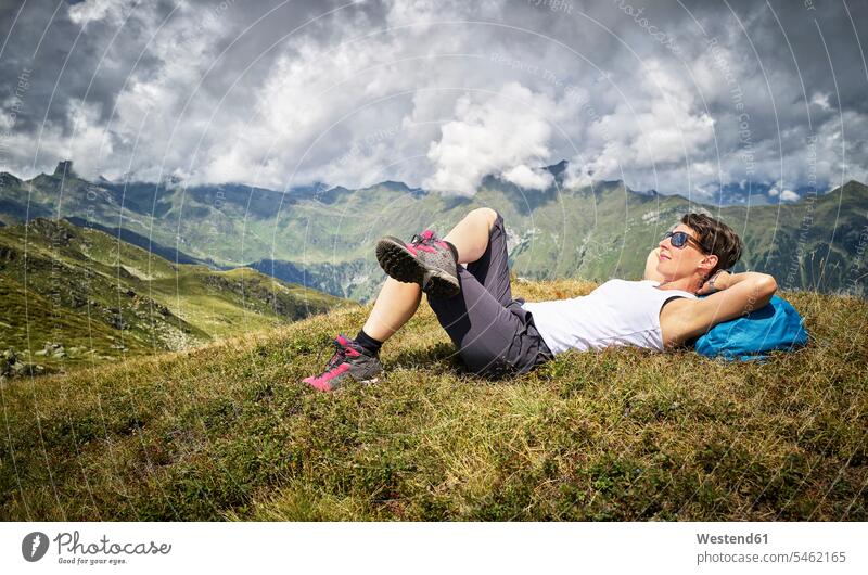 Woman having a break from hiking lying on alpine meadow, Passeier Valley, South Tyrol, Italy human human being human beings humans person persons