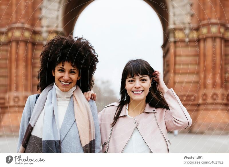 Spain, Barcelona, portrait of two happy women at a gate portraits happiness gates woman females female friends Adults grown-ups grownups adult people persons