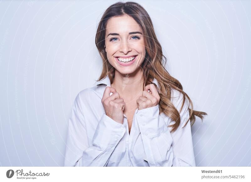 Portrait of laughing young woman wearing white blouse Laughter portrait portraits blouses females women positive Emotion Feeling Feelings Sentiments Emotions