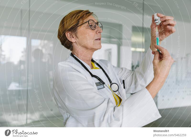Doctor preparing a vaccine for patient Occupation Work job jobs profession professional occupation glass panes health healthcare Healthcare And Medicines