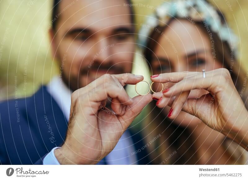 Happy bridal couple showing their wedding rings, close-up happiness happy Showing Wedding Bands bridal couples jewellery jewelry married couple married couples