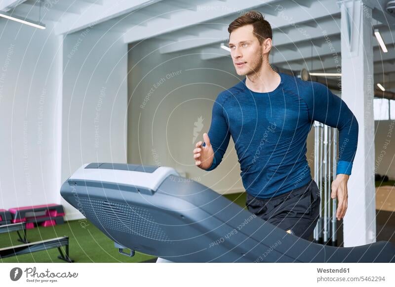 Man running on treadmill at gym Treadmills running machine gyms Health Club exercise equipment Exercising Equipment exercise machines fitness sport sports