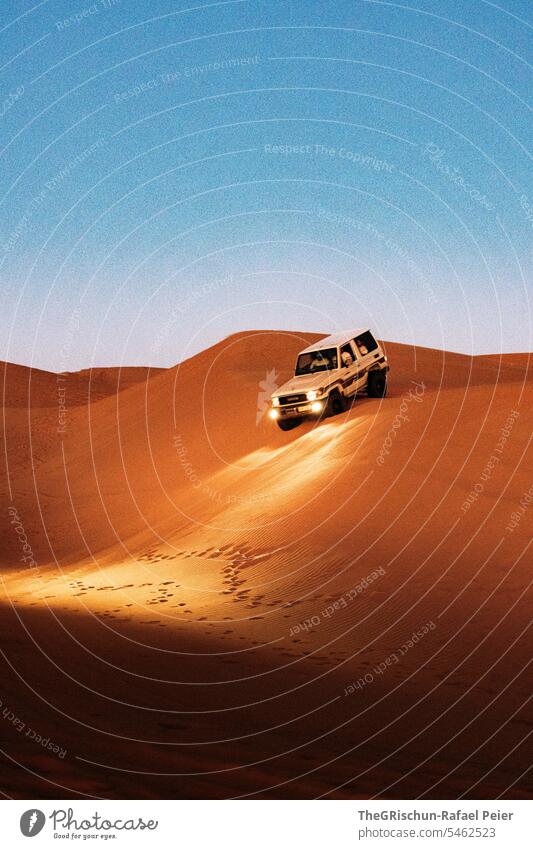 Car drives down the dune at dusk Motoring Sand Tracks Light duene men men's toys Vacation & Travel Nature Landscape Desert Exterior shot car Oman Adventure