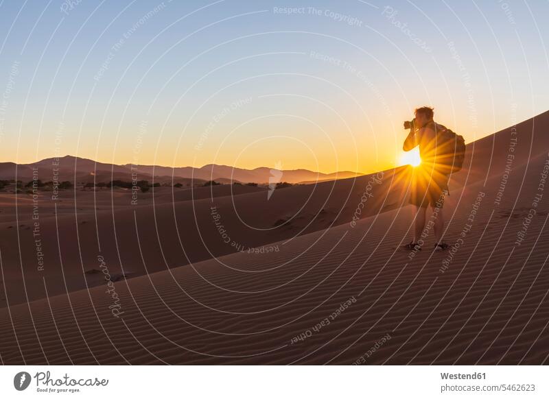 Africa, Namibia, Namib desert, Naukluft National Park, photographer on dune during sunrise tourist tourists photographers photographing National Parks