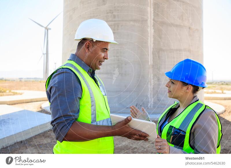 Two engineers with tablet discussing on a wind farm digitizer Tablet Computer Tablet PC Tablet Computers iPad Digital Tablet digital tablets discussion