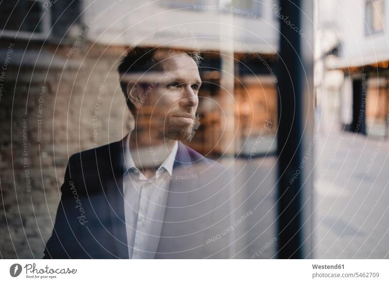 Portrait of businessman looking out of window Occupation Work job jobs profession professional occupation business life business world business person