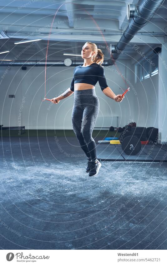 Athletic woman skipping with jumping rope in gym workout working out work out gyms Health Club skipping rope skip rope jump rope Jumping Ropes females women