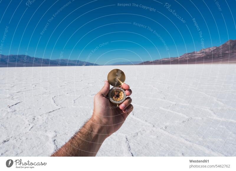 USA, California, Death Valley, man's hand holding compass human hand hands human hands compasses navigational compass men males people persons human being