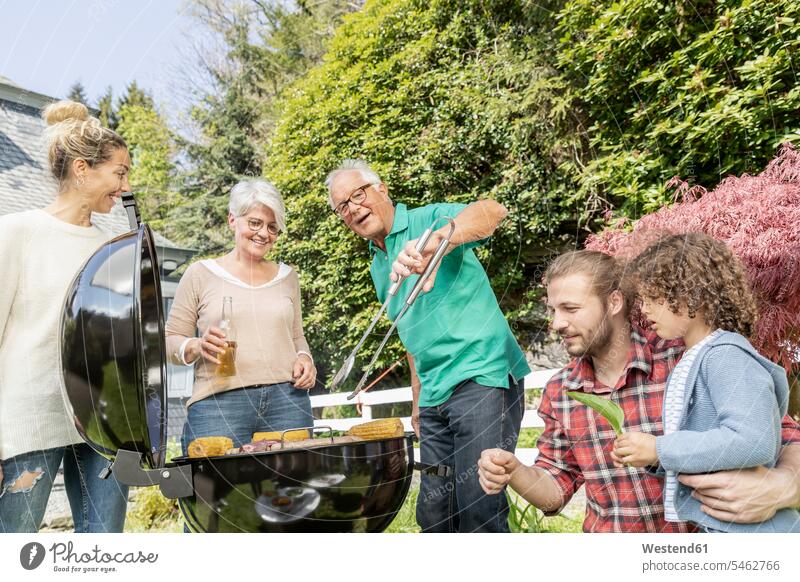 Extended family having a barbecue in garden generation human human being human beings humans person persons families Multi Generations Families