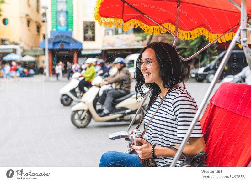 Vietnam, Hanoi, happy young woman on a riksha exploring the city Exploration explore Riksha town cities towns females women happiness transportation outdoors