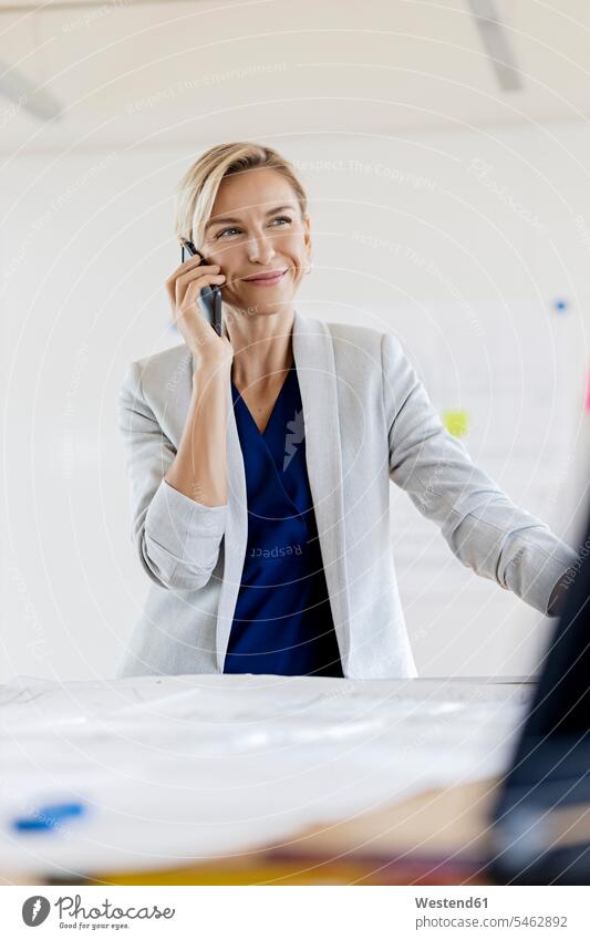 Blond businesswoman on the phone in conference room Occupation Work job jobs profession professional occupation business life business world business person
