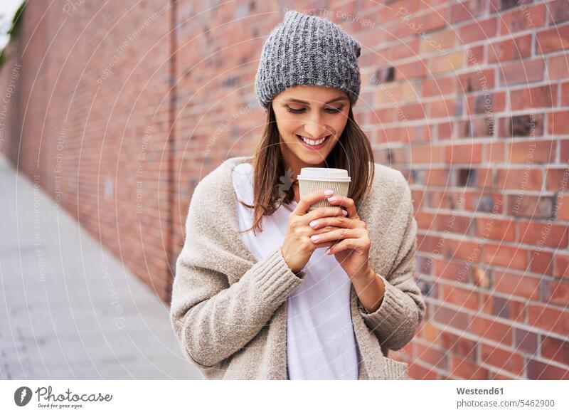 Happy woman with coffee to go Coffee Coffee to Go takeaway coffee happiness happy females women Drink beverages Drinks Beverage food and drink Nutrition