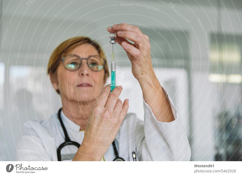 Doctor preparing a vaccine for patient Occupation Work job jobs profession professional occupation glass panes health healthcare Healthcare And Medicines