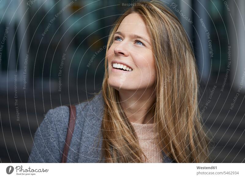 Portrait of smiling businesswoman watching something smile portrait portraits businesswomen business woman business women looking looking at business people