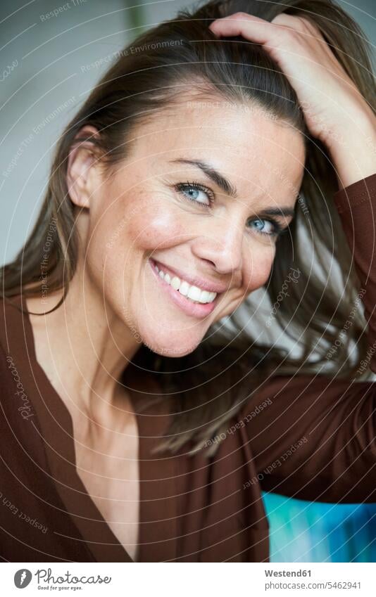 Portrait of smiling brunette woman with hand in hair business life business world business person businesspeople business woman business women businesswomen