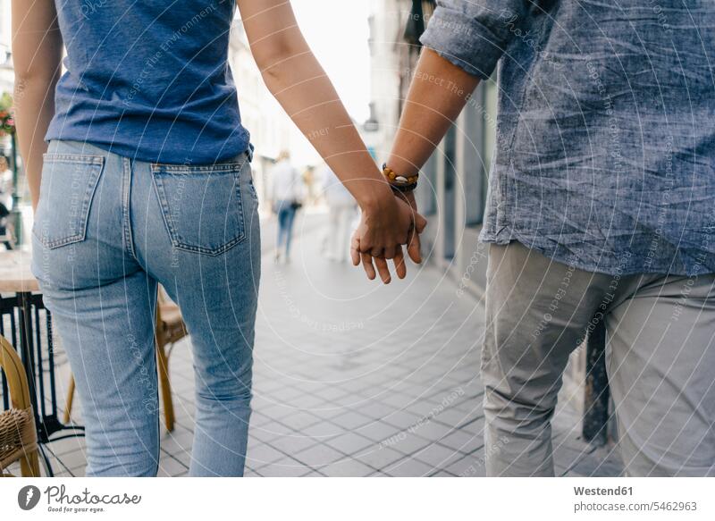 Netherlands, Maastricht, close-up of young couple walking hand in hand in the city going town cities towns twosomes partnership couples outdoors outdoor shots