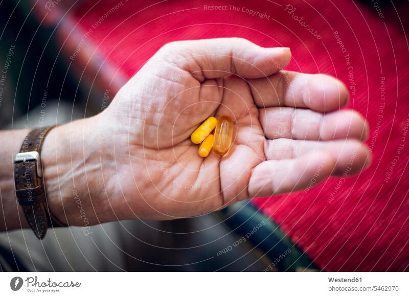 Senior holding pills in his hand human human being human beings humans person persons caucasian appearance caucasian ethnicity european 1 one person only