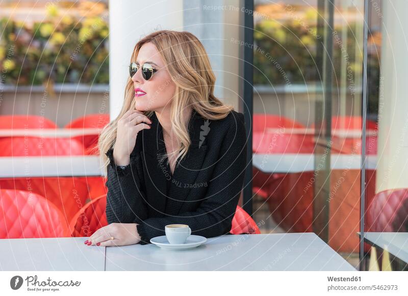 Businesswoman with sunglasses after work with a coffee, looking sideways human human being human beings humans person persons caucasian appearance