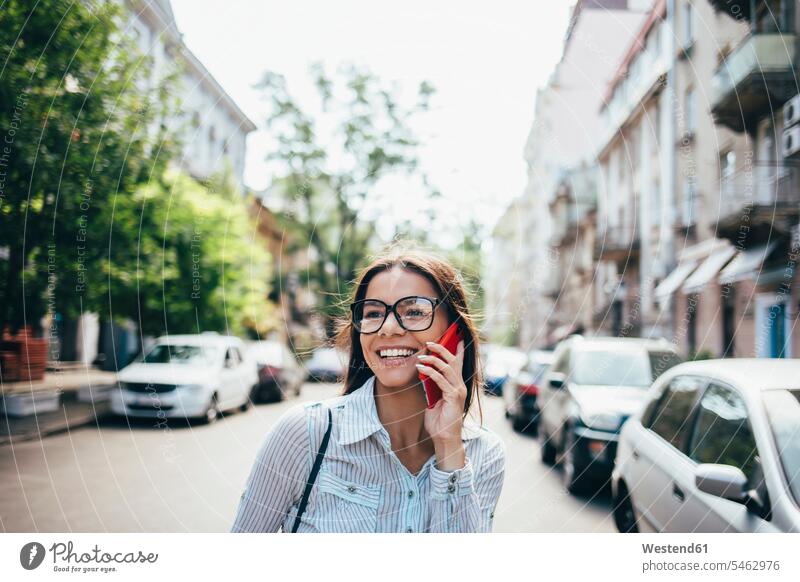 Happy young businesswoman talking on cell phone on the street human human being human beings humans person persons 1 one person only only one person adult