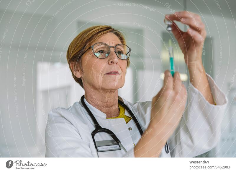 Doctor preparing a vaccine for patient Occupation Work job jobs profession professional occupation health healthcare Healthcare And Medicines medical medicine