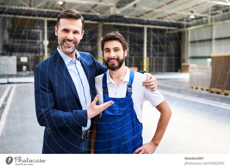 Portrait of happy businessman and worker in a factory Occupation Work job jobs profession professional occupation blue collar blue collar worker