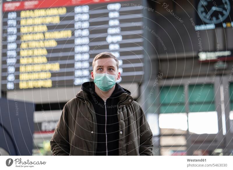Young man with face mask at train station in the city display panels health healthcare Healthcare And Medicines medical medicine healthy protect protecting safe