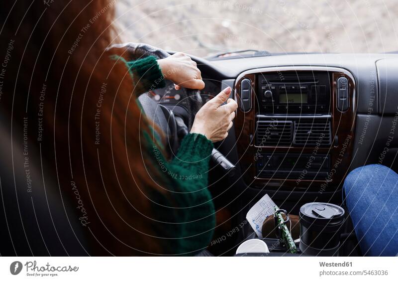 Back view of woman driving car on mountian road Mountain Road Mountain Roads car driving motoring females women streets roads automobile Auto cars motorcars