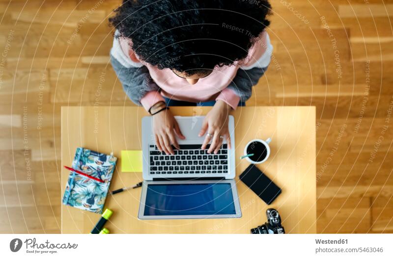 Top view of young woman working from home using laptop human human being human beings humans person persons celibate celibates singles solitary people