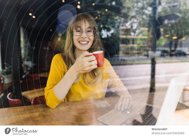 Portrait of smiling woman with laptop and coffee in a cafe Occupation Work job jobs profession professional occupation business life business world