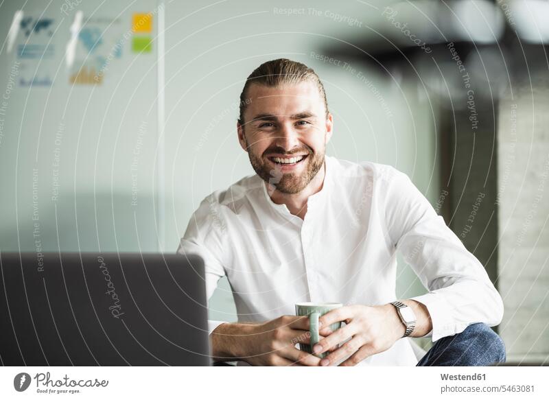Portrait of smiling young businessman in office smile Businessman Business man Businessmen Business men offices office room office rooms portrait portraits