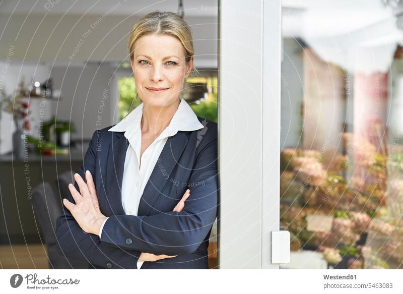 Portrait of confident businesswoman leaning against French door at home females women portrait portraits French Door confidence businesswomen business woman