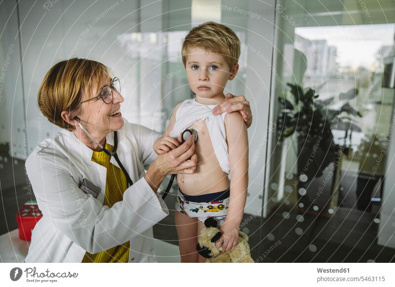 Doctor examining toddler boy with a stethoscope health healthcare Healthcare And Medicines medical medicine disease diseases ill illnesses sick Sickness