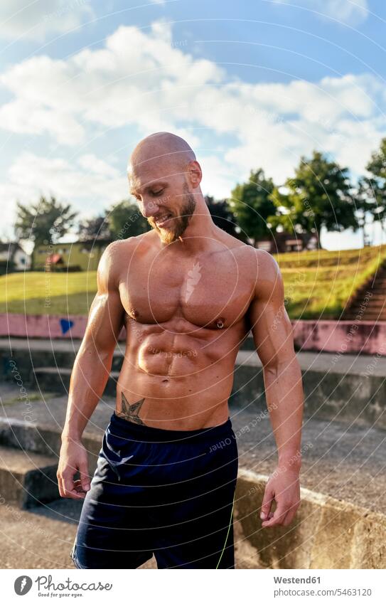 Portrait of smiling barechested muscular man outdoors portrait portraits men males muscles athletic smile Adults grown-ups grownups adult people persons