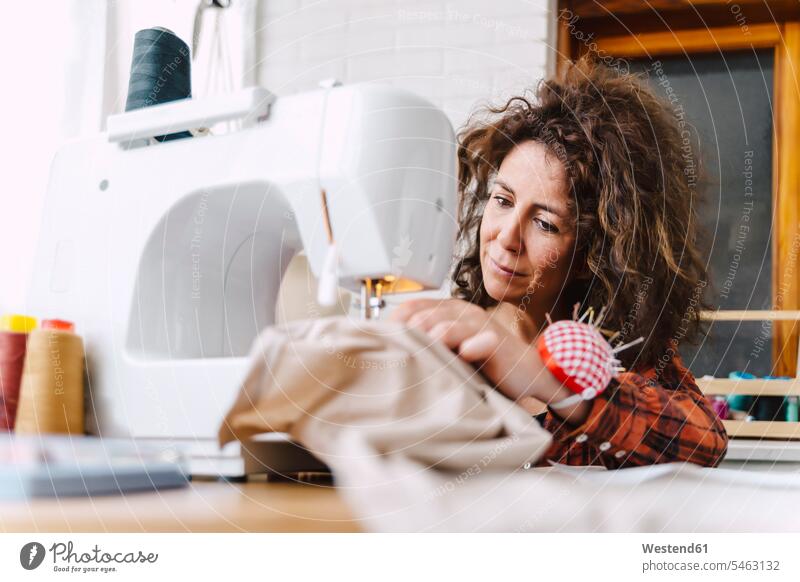 Woman sewing at home Occupation Work job jobs profession professional occupation human human being human beings humans person persons curl curled curls