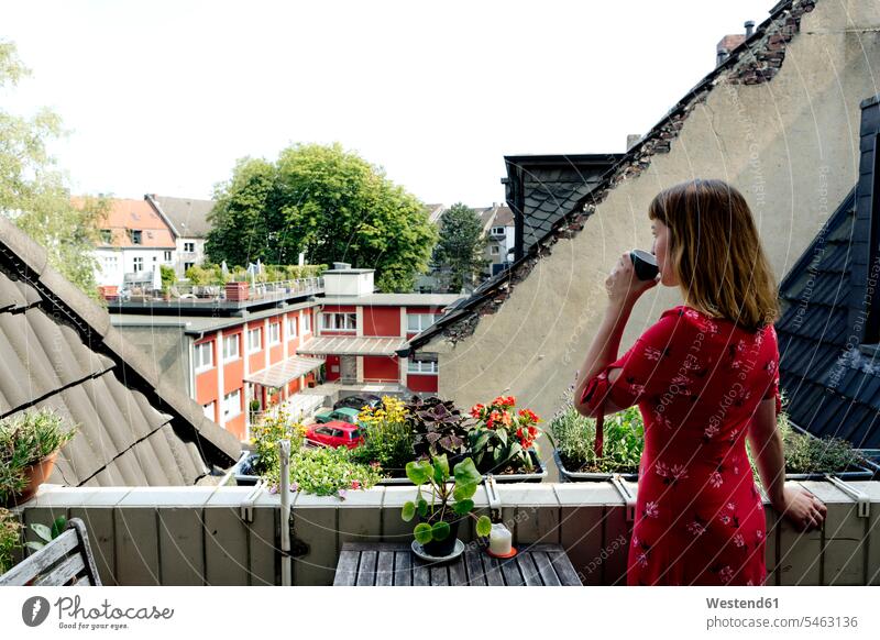 Young woman relaxing with cup of coffee on balcony looking at distance human human being human beings humans person persons caucasian appearance