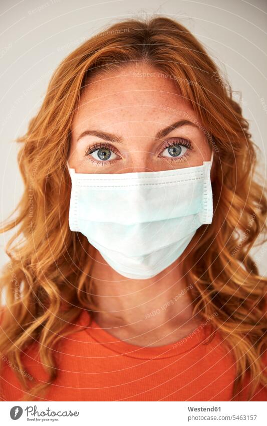 Portrait of red-haired woman wearing a protective mask at home healthy protecting safe Safety secure dangerous Attractiveness beautiful good-looking Handsome