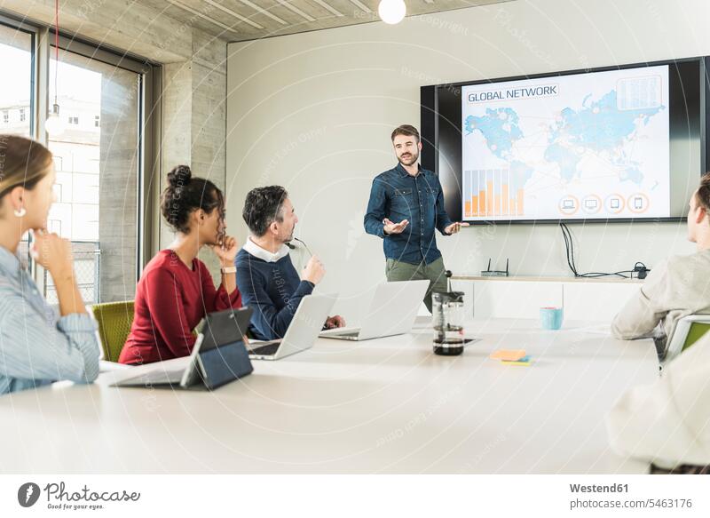 Young businessman leading a presentation in boardroom colleague associate associates partner partners partnerships Occupation Work job jobs profession
