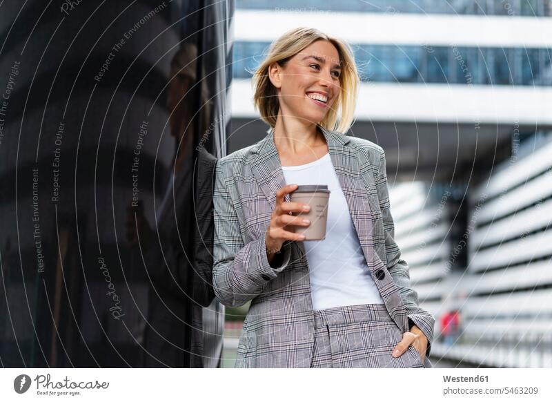 Happy young businesswoman with takeaway coffee in the city business life business world business person businesspeople business woman business women