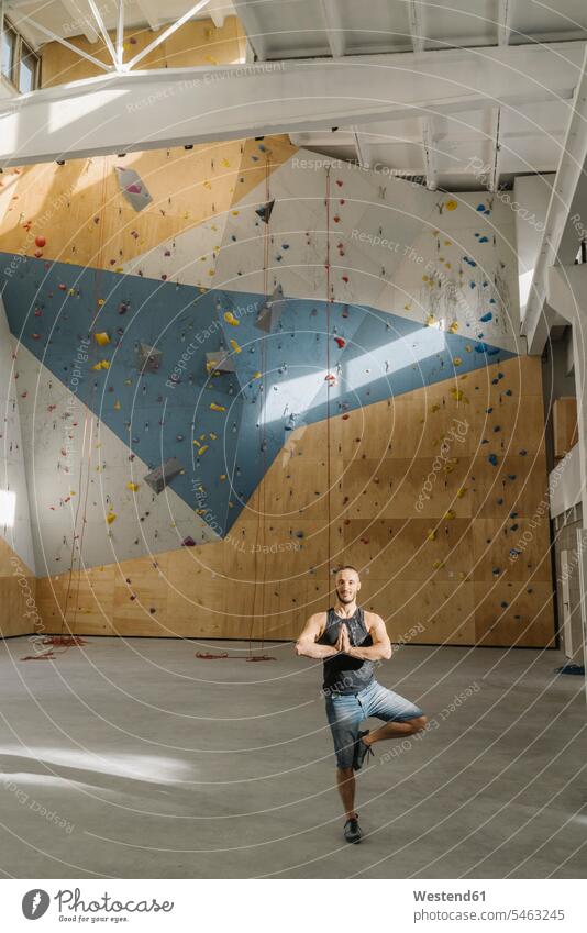Man standing in yoga pose in climbing gym (value=0) human human being human beings humans person persons caucasian appearance caucasian ethnicity european 1