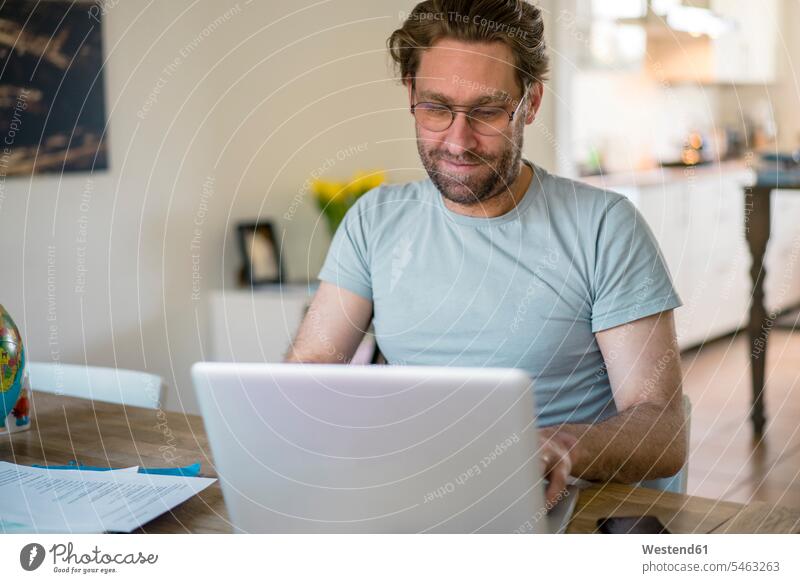 Freelancer using laptop in home office color image colour image indoors indoor shot indoor shots interior interior view Interiors day daylight shot