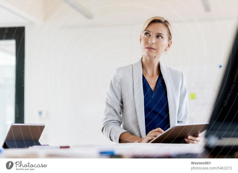Blond businesswoman using tablet in conference room human human being human beings humans person persons caucasian appearance caucasian ethnicity european 1