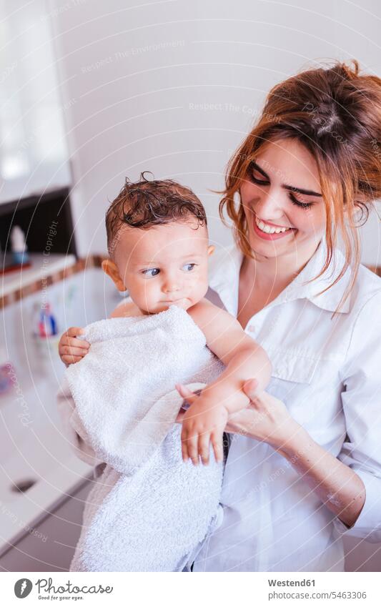 Mother toweling her little son human human being human beings humans person persons families mama mom mommy mothers mummy children man child man children towels