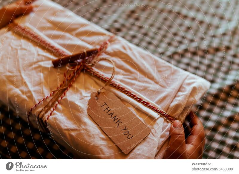 Hands of boy holding Christmas present at on table home color image colour image Spain Christmas presents Christmas Gift gift gifts Surprise surprising X mas